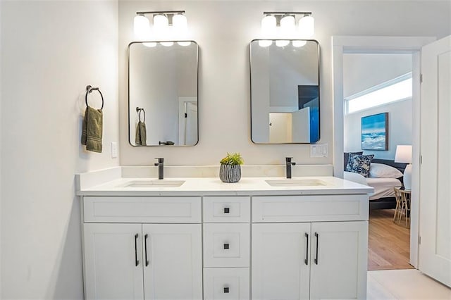 full bathroom featuring ensuite bath, double vanity, and a sink