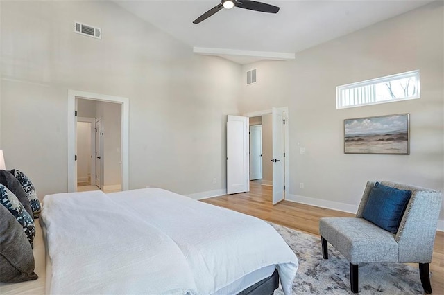 bedroom featuring wood finished floors, visible vents, and baseboards