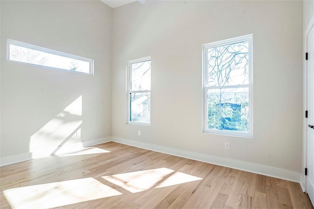 foyer entrance featuring light wood-style flooring and baseboards