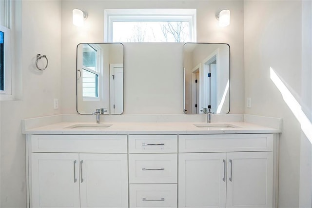 bathroom with a sink and double vanity