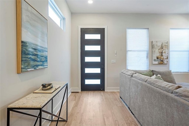 foyer entrance featuring recessed lighting, baseboards, and light wood finished floors