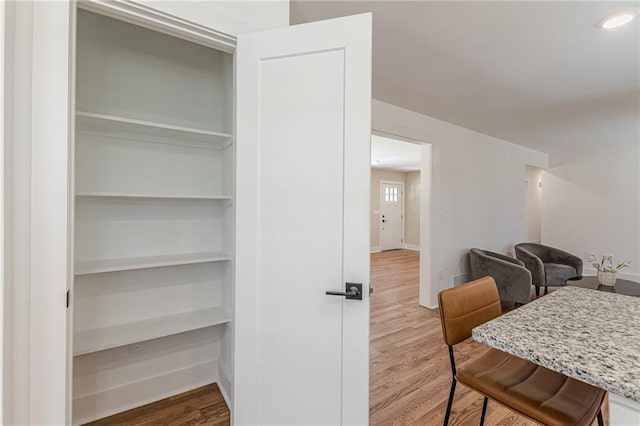 interior space with recessed lighting, baseboards, and wood finished floors