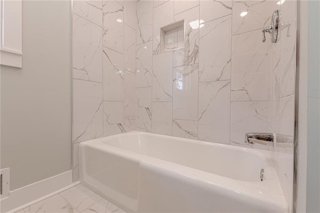 bathroom with marble finish floor, baseboards, and bathtub / shower combination