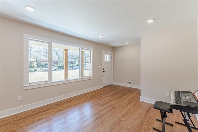 foyer entrance with light wood finished floors, visible vents, recessed lighting, and baseboards