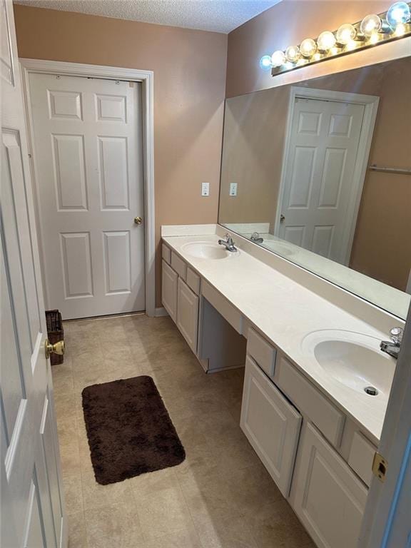 2191 Rockbridge Rd Unit 2603, Stone Mountain, GA 30087 - full bathroom featuring double vanity and a textured ceiling