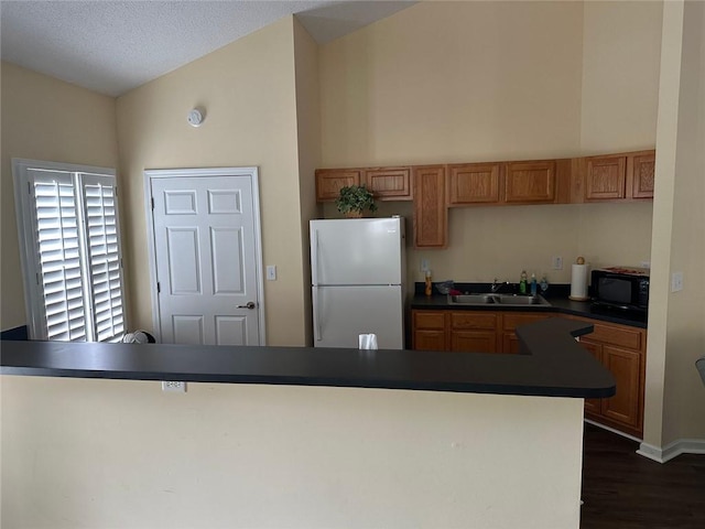 2191 Rockbridge Rd Unit 2603, Stone Mountain, GA 30087 - kitchen featuring freestanding refrigerator, a sink, black microwave, dark countertops, and dark wood-style floors