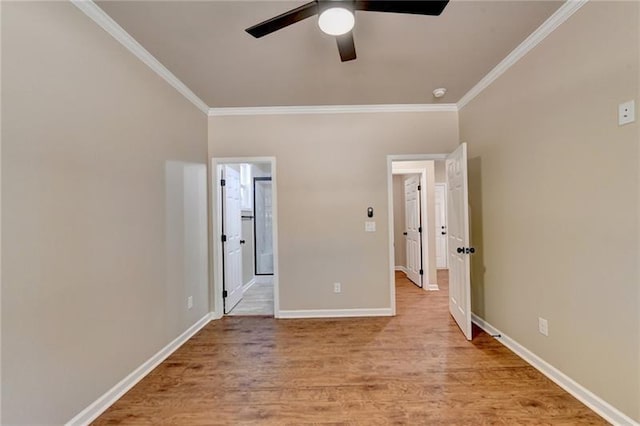 unfurnished bedroom with light wood-type flooring, ornamental molding, baseboards, and connected bathroom