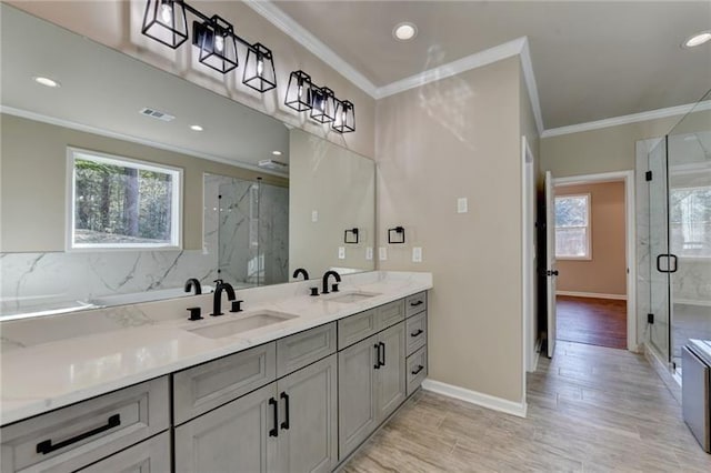 bathroom with a sink, plenty of natural light, and visible vents