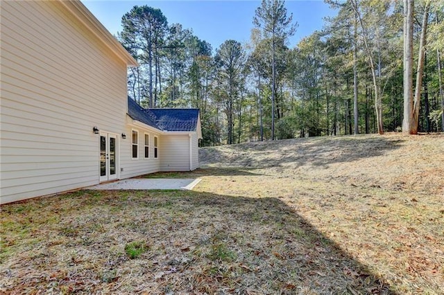 view of yard featuring a patio and french doors