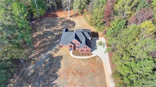 drone / aerial view with a wooded view