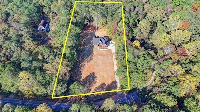 birds eye view of property featuring a view of trees