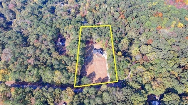 birds eye view of property featuring a wooded view