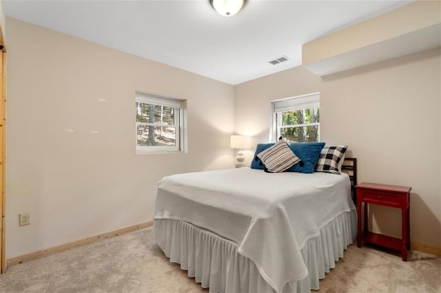 bedroom with light colored carpet