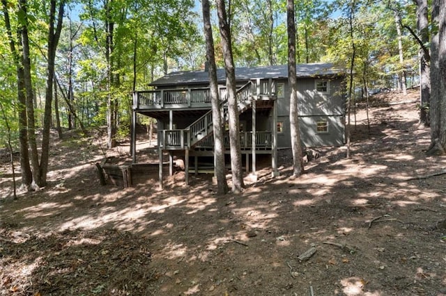 rear view of property featuring a wooden deck