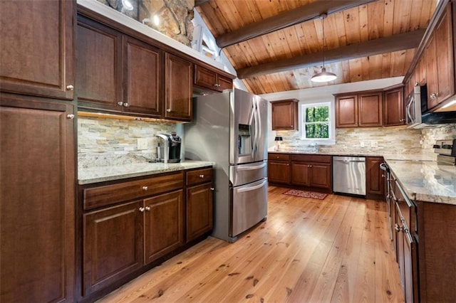 kitchen with stainless steel appliances, tasteful backsplash, light stone countertops, decorative light fixtures, and light wood-type flooring