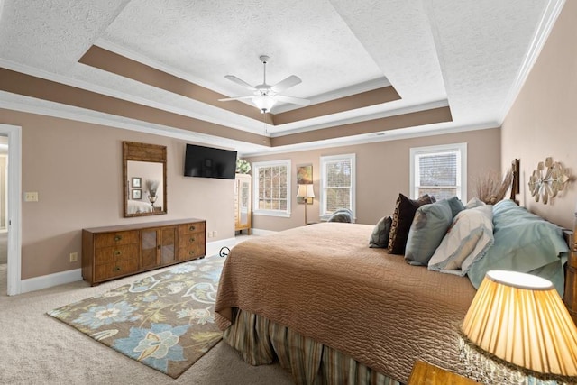 bedroom featuring crown molding, a textured ceiling, a raised ceiling, ceiling fan, and carpet