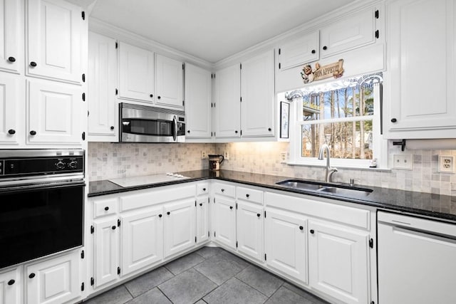 kitchen featuring sink, white cabinetry, white dishwasher, electric stovetop, and oven