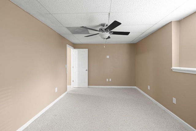 empty room with carpet flooring, a paneled ceiling, and ceiling fan