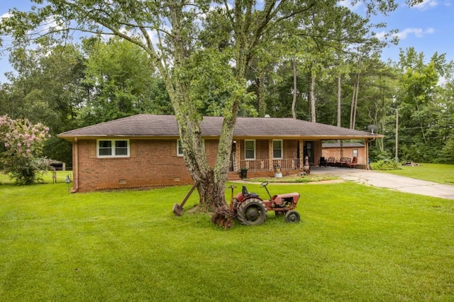 single story home featuring a porch, a carport, and a front lawn