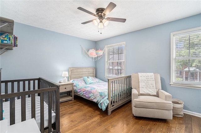 6700 Roswell Rd NE Unit 25A, Sandy Springs, GA 30328 - bedroom featuring wood finished floors, ceiling fan, baseboards, and a textured ceiling