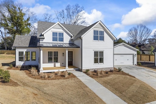 modern farmhouse with metal roof, covered porch, a shingled roof, concrete driveway, and a standing seam roof