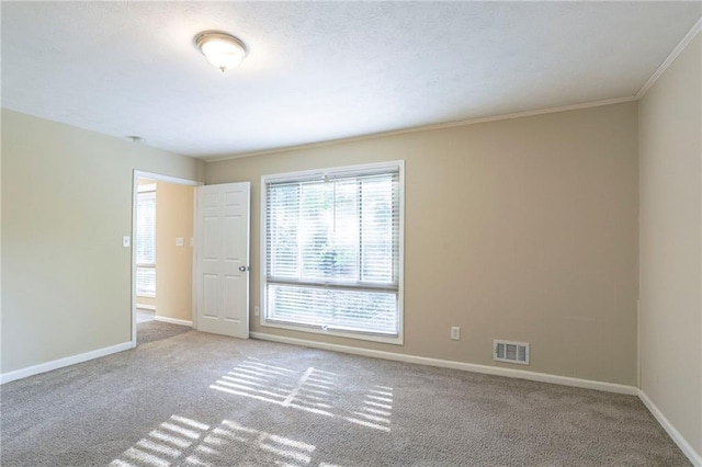 unfurnished room with light colored carpet and ornamental molding