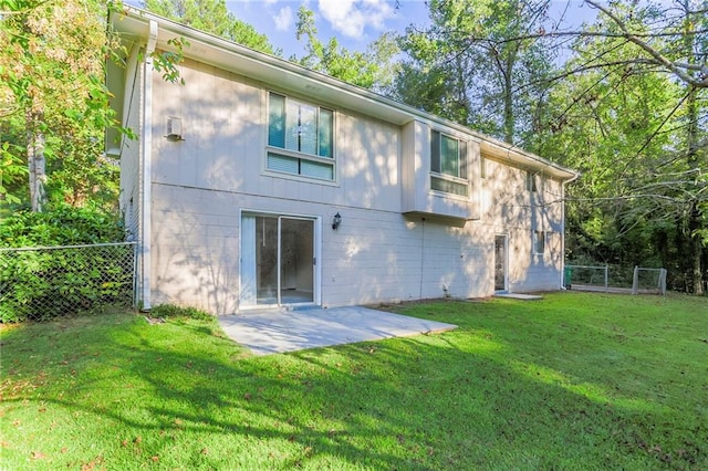 back of property featuring a yard and a patio