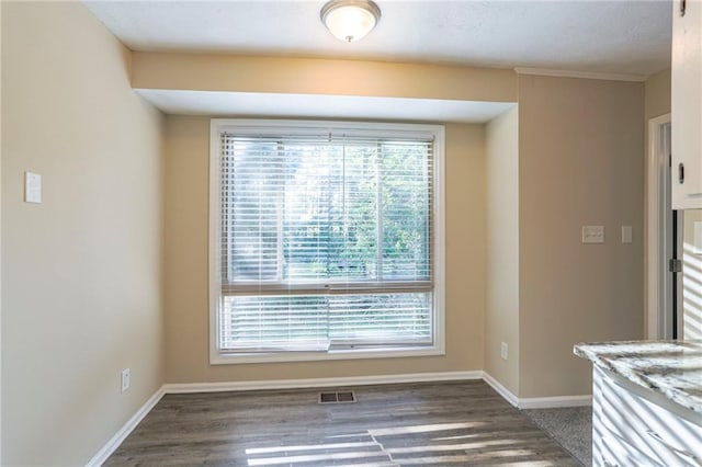 unfurnished dining area with dark hardwood / wood-style flooring