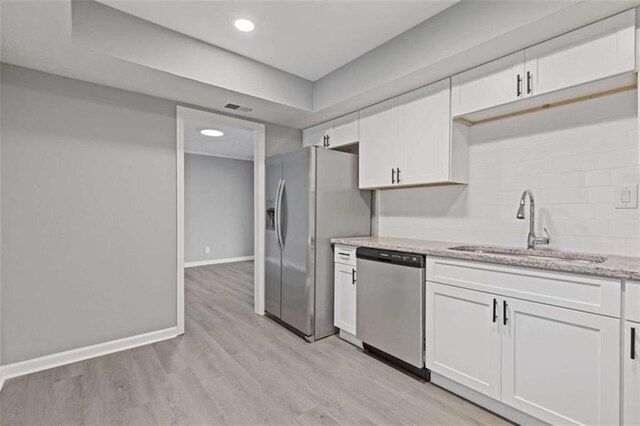 3236 Henderson Mill Rd Unit 5, Atlanta, GA 30341 - kitchen with appliances with stainless steel finishes, white cabinets, light stone counters, decorative backsplash, and recessed lighting