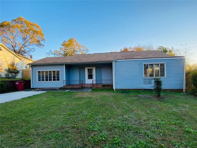 single story home with a front lawn and a porch