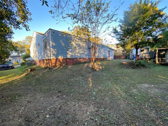 view of side of property with a lawn