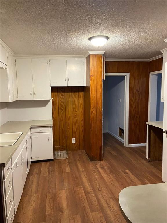 kitchen featuring white cabinets, sink, and a textured ceiling