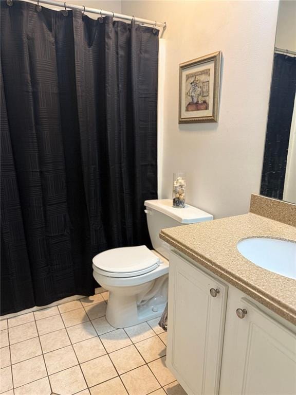 full bath featuring vanity, toilet, and tile patterned floors