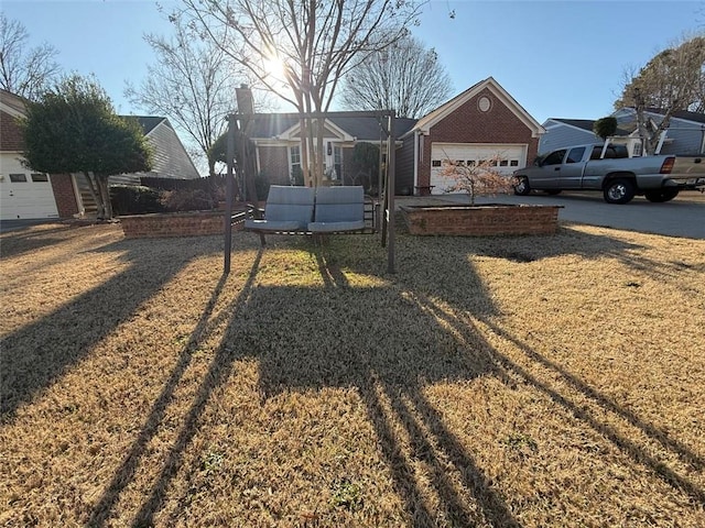 exterior space with a front lawn and an attached garage