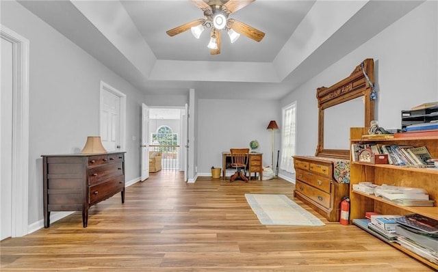 190 Crestworth Ct, Powder Springs, GA 30127 - sitting room featuring a tray ceiling, a ceiling fan, light wood-style floors, and baseboards
