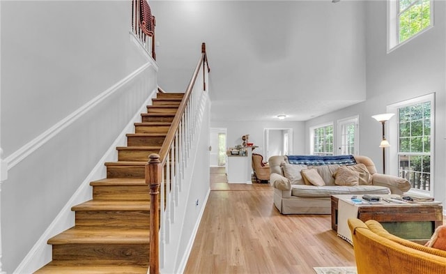 190 Crestworth Ct, Powder Springs, GA 30127 - stairway featuring healthy amount of natural light, a towering ceiling, and wood finished floors