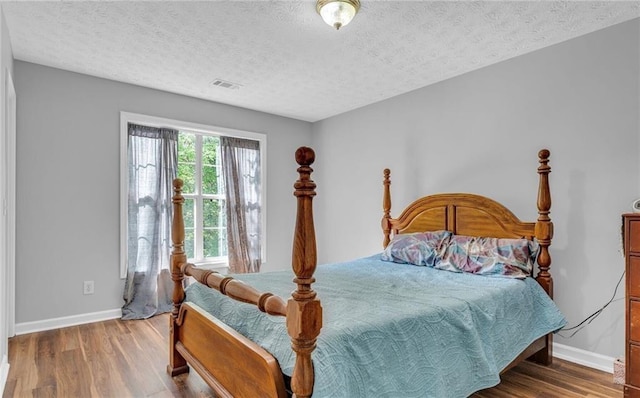 190 Crestworth Ct, Powder Springs, GA 30127 - bedroom featuring baseboards, wood finished floors, and a textured ceiling