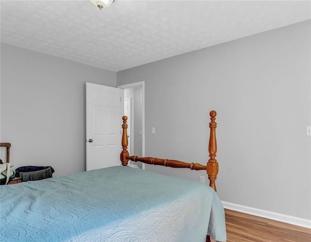 190 Crestworth Ct, Powder Springs, GA 30127 - bedroom featuring wood finished floors, baseboards, and a textured ceiling