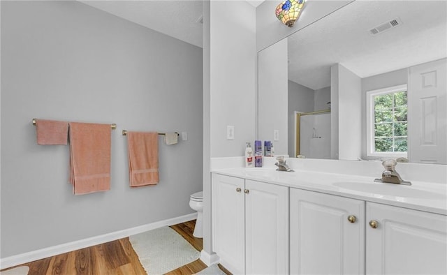 190 Crestworth Ct, Powder Springs, GA 30127 - full bath featuring wood finished floors, an enclosed shower, toilet, double vanity, and baseboards