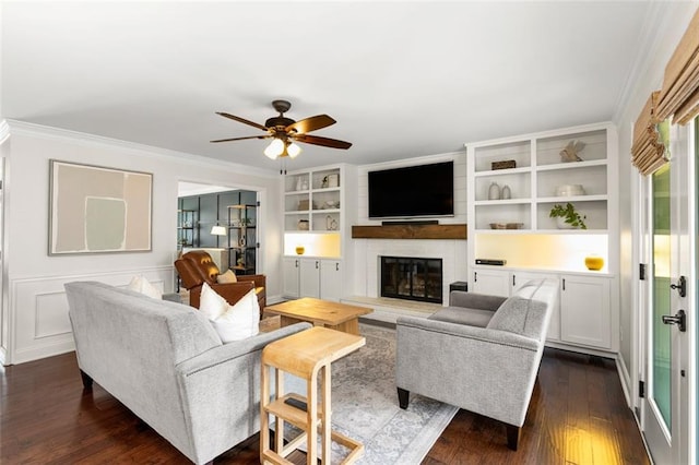 3710 Robinson Walk Ct, Marietta, GA 30068 - living room with crown molding, dark wood-type flooring, a ceiling fan, a fireplace, and built in shelves