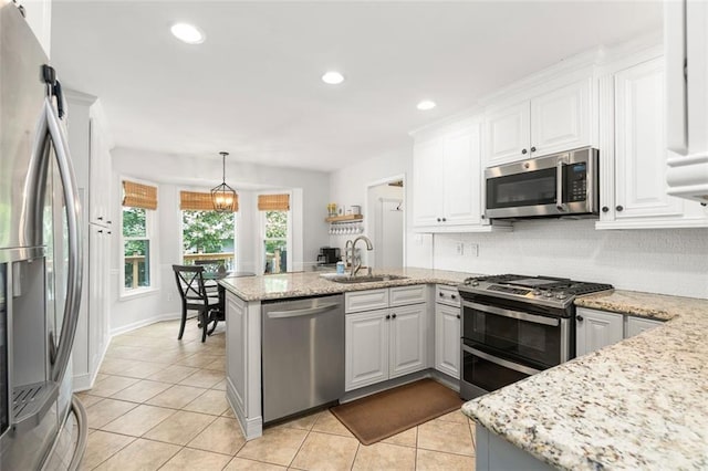 3710 Robinson Walk Ct, Marietta, GA 30068 - kitchen with appliances with stainless steel finishes, a sink, light tile patterned flooring, a peninsula, and recessed lighting