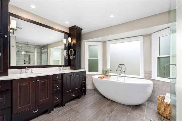 3710 Robinson Walk Ct, Marietta, GA 30068 - bathroom featuring tile walls, a stall shower, double vanity, a soaking tub, and wainscoting