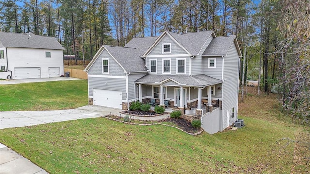 view of front of home with central AC, a garage, covered porch, and a front lawn