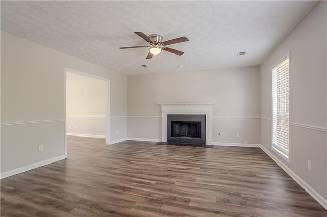 1797 Emerson Lake Cir, Snellville, GA 30078 - unfurnished living room featuring plenty of natural light, dark wood-type flooring, and a textured ceiling