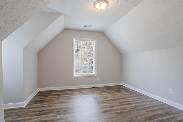 1797 Emerson Lake Cir, Snellville, GA 30078 - bonus room featuring a textured ceiling, wood finished floors, and lofted ceiling