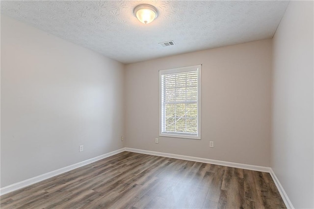 1797 Emerson Lake Cir, Snellville, GA 30078 - spare room with wood finished floors and a textured ceiling