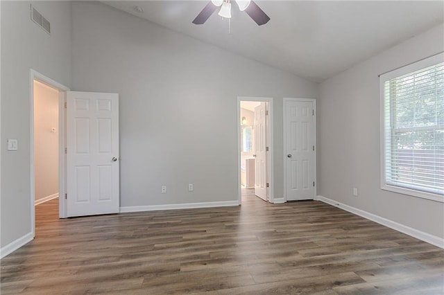 1797 Emerson Lake Cir, Snellville, GA 30078 - unfurnished bedroom featuring dark wood-type flooring, ensuite bathroom, ceiling fan, and high vaulted ceiling