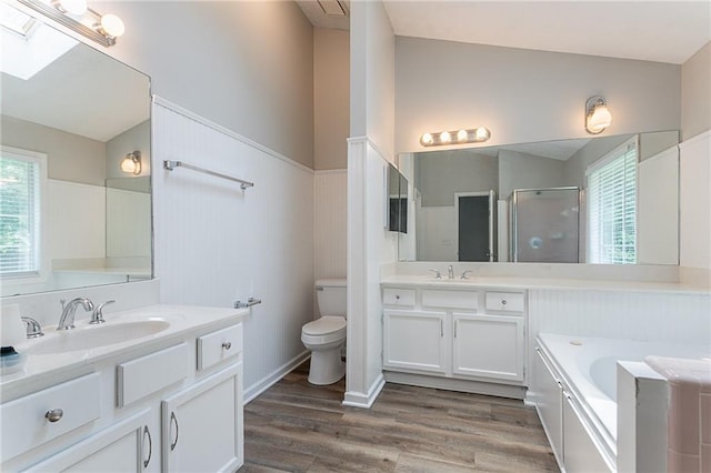 1797 Emerson Lake Cir, Snellville, GA 30078 - full bathroom with two vanities, a shower stall, wood finished floors, a bath, and wainscoting