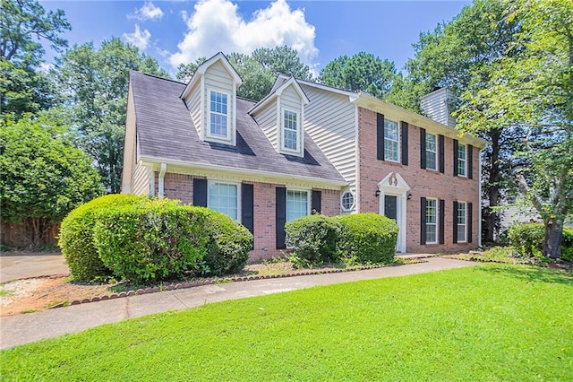 1797 Emerson Lake Cir, Snellville, GA 30078 - view of front of house with a front lawn, brick siding, and a chimney