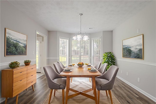 1797 Emerson Lake Cir, Snellville, GA 30078 - dining room with wood finished floors, a chandelier, and a textured ceiling
